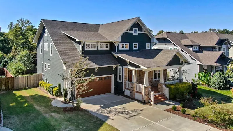 Professional roofer installing asphalt shingles on a Cache Valley, Utah home